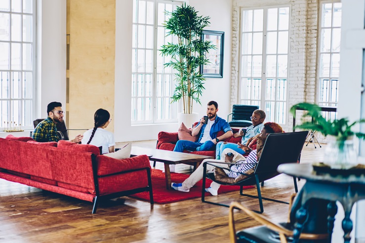 group of people sitting on couches and talking